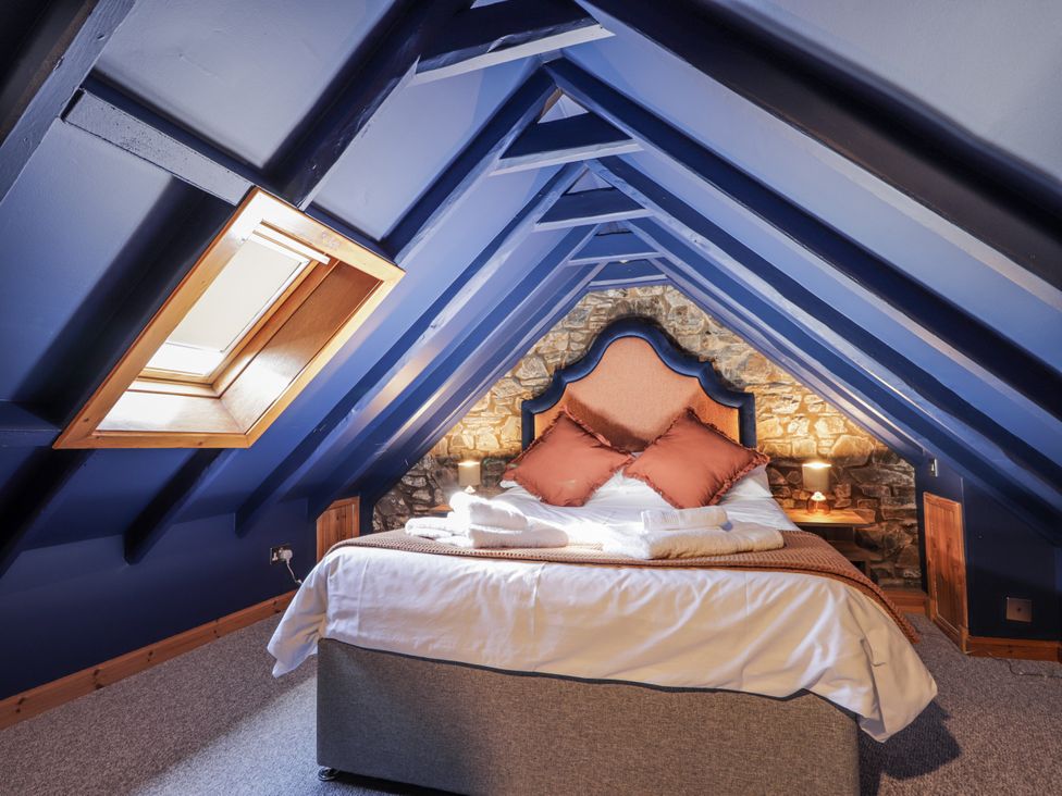 A bedroom with a bed and a skylight at 83 Seatown in Cullen