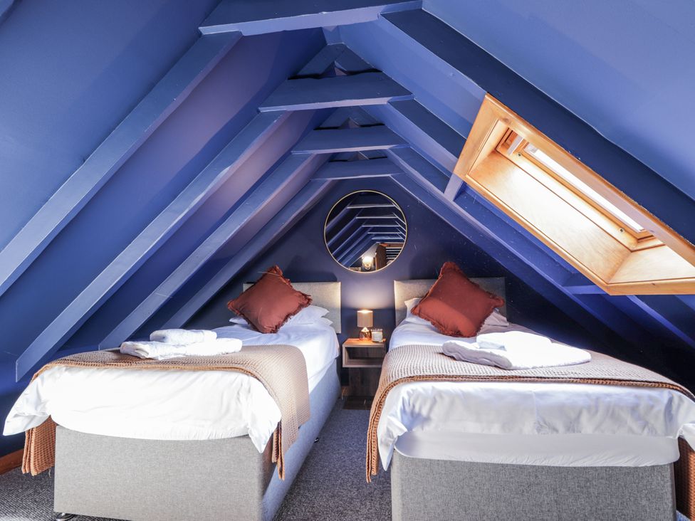 A bedroom with two beds and a skylight at 83 Seatown, Cullen