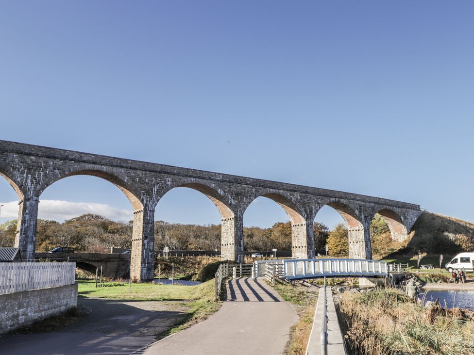 A viaduct with arches and a bridge in a landscape at 83 Seatown, Cullen