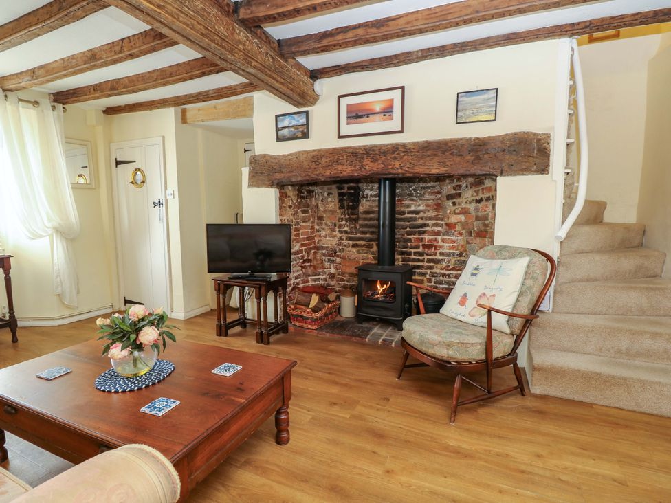 A living room with a fireplace and sofa at Tovah in Yarmouth