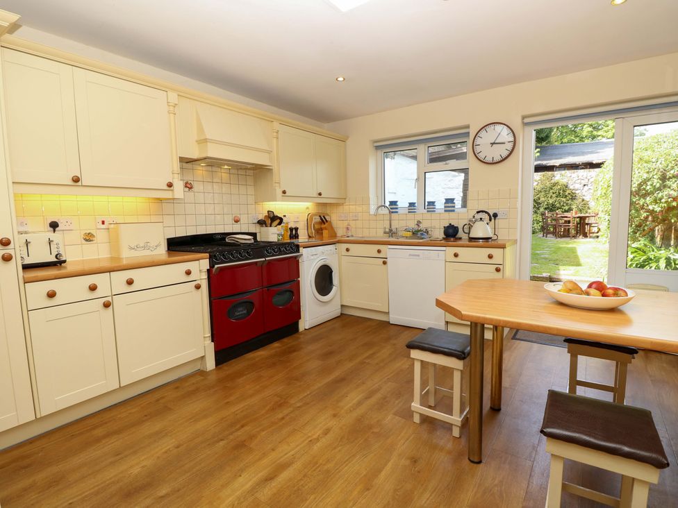 A kitchen with a table and appliances at Tovah Yarmouth
