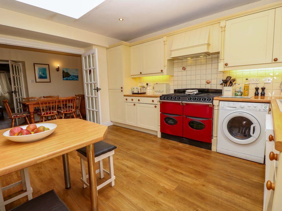 A kitchen with appliances and dining area at Tovah in Yarmouth