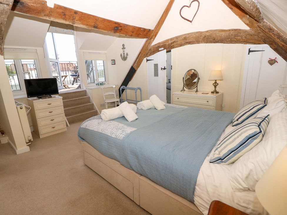 A bedroom with a bed and television at Tovah in Yarmouth