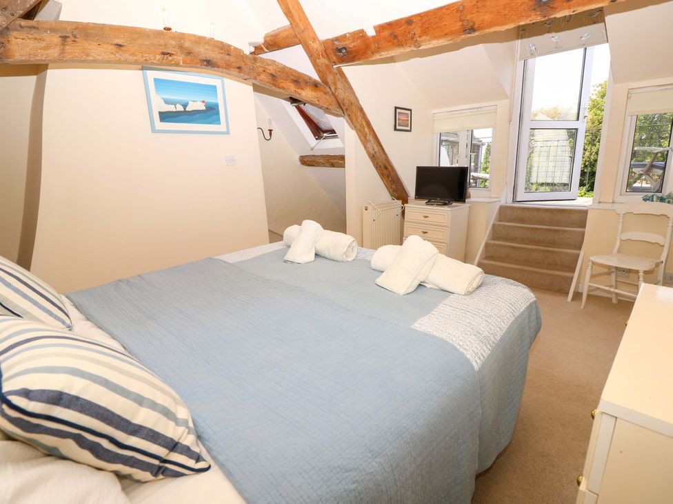 A bedroom with a bed and television at Tovah in Yarmouth