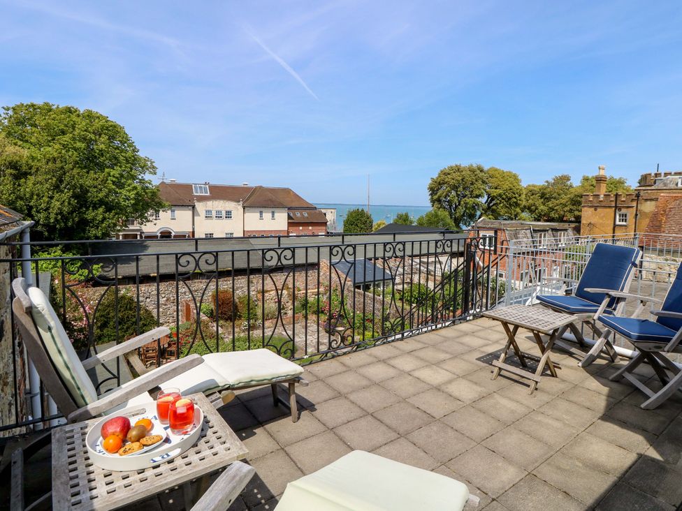 A balcony view with seating and snacks at Tovah in Yarmouth