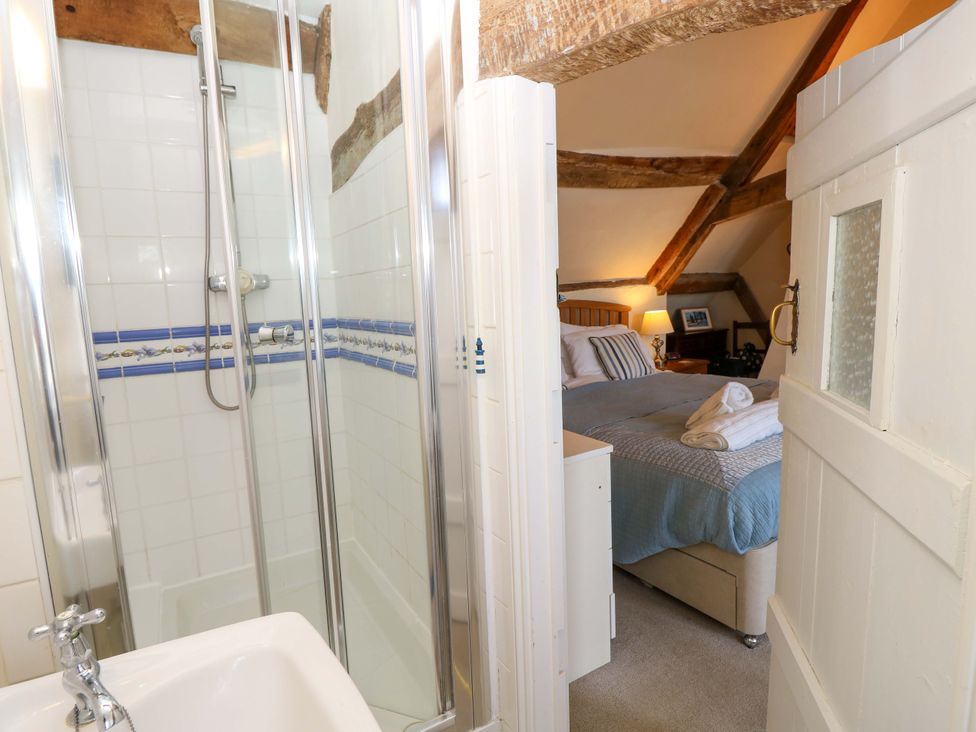 A bathroom with a shower and a view of a bedroom at Tovah in Yarmouth