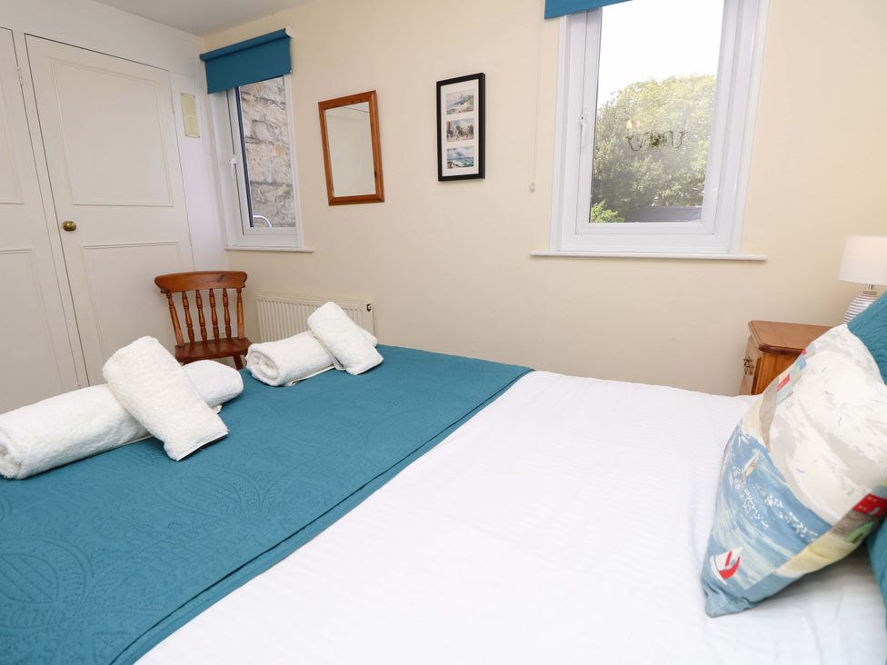 A bedroom with a bed and a chair at Tovah in Yarmouth