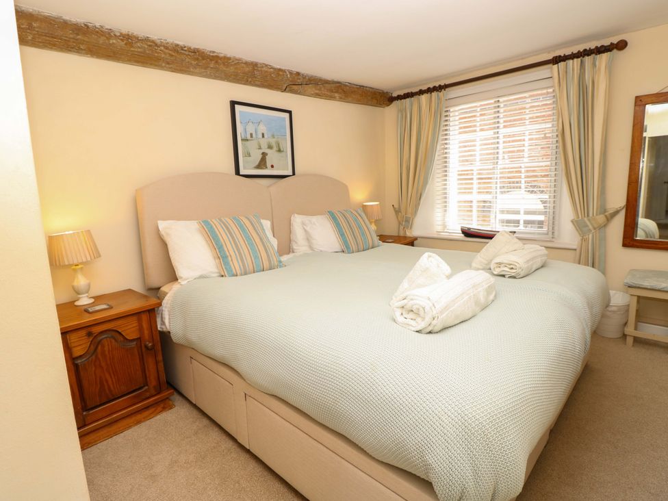 A bedroom with a large bed and bedside table at Tovah in Yarmouth