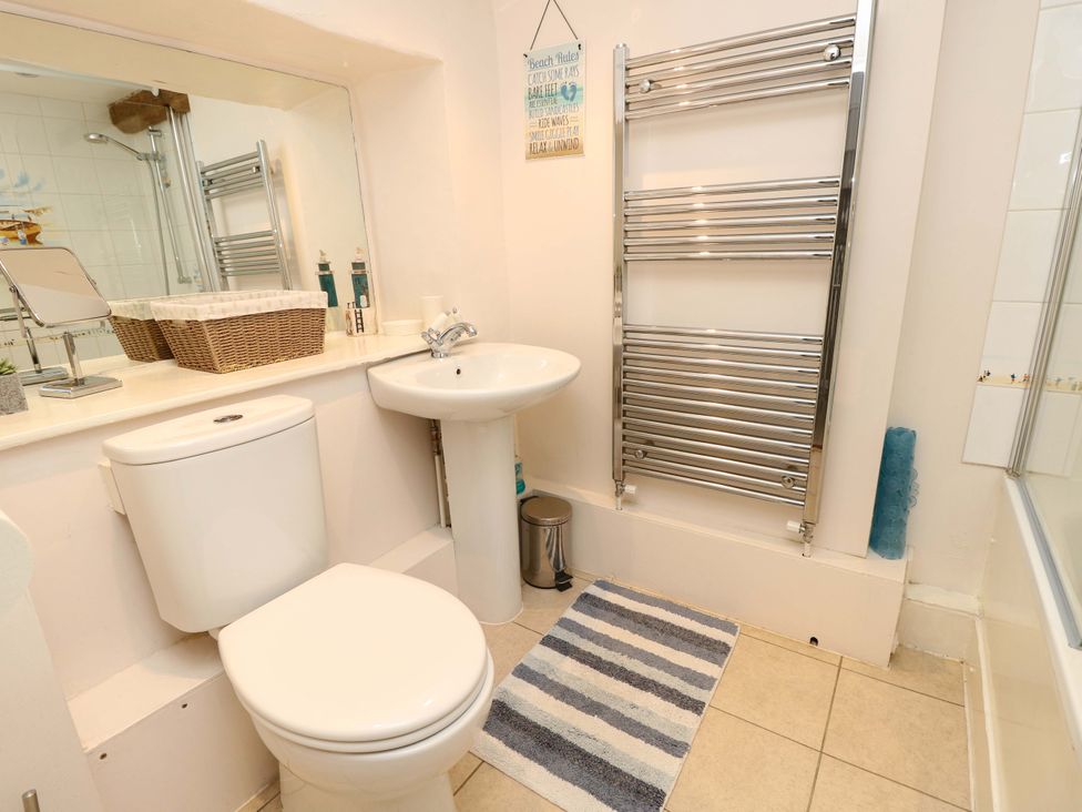 A bathroom with a sink and toilet at Tovah in Yarmouth