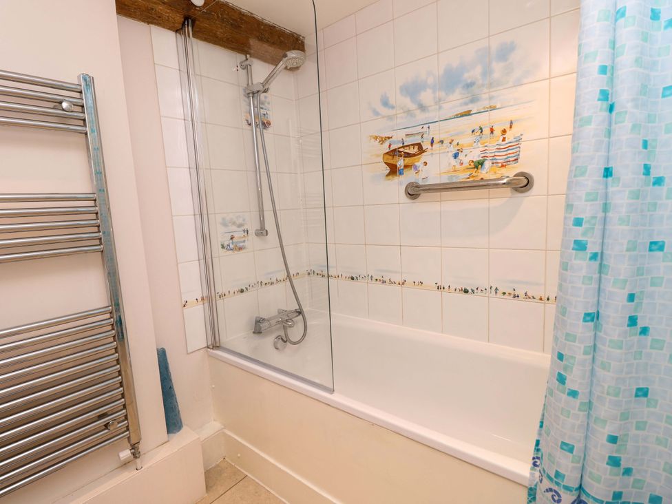 A bathroom with a bathtub and shower at Tovah in Yarmouth