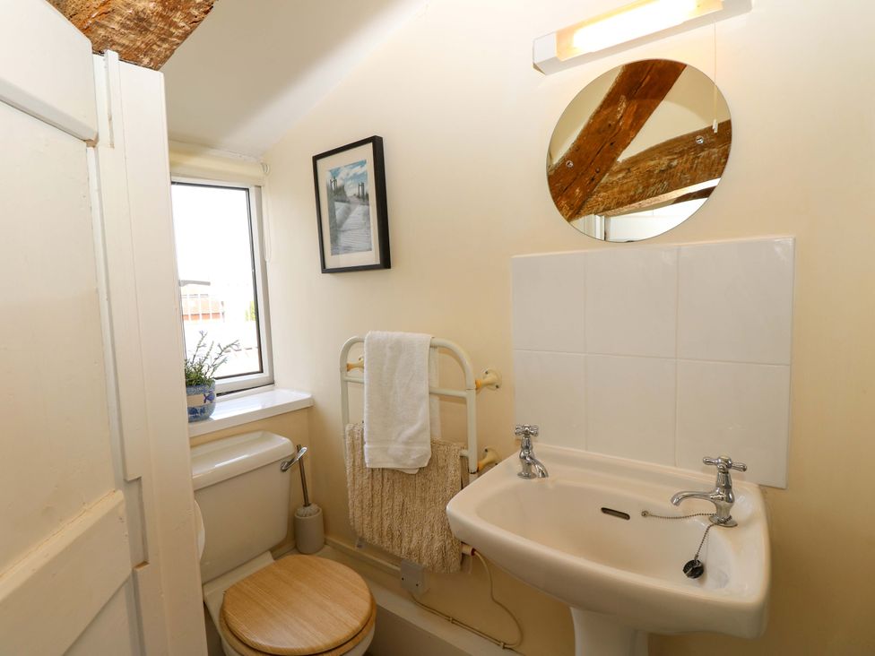 A bathroom with a toilet and hand basin at Tovah in Yarmouth