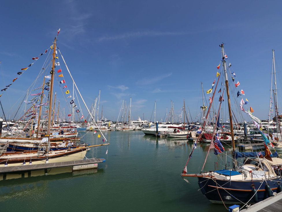 A marina with various boats and flags at Tovah in Yarmouth