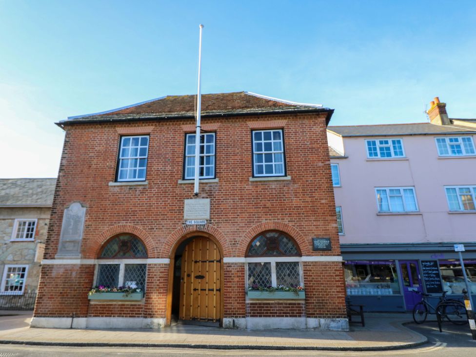 A brick building with windows and an entrance door at Tovah in Yarmouth