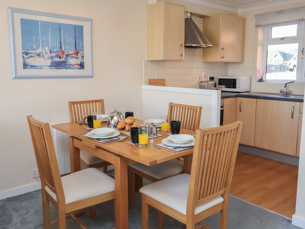 A dining room with a table set for breakfast at Daisy Lodge in Norwich