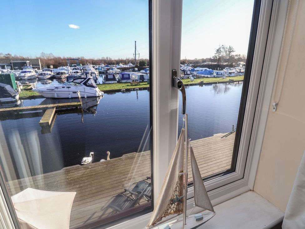 A view from a window showing boats and water at Daisy Lodge in Norwich