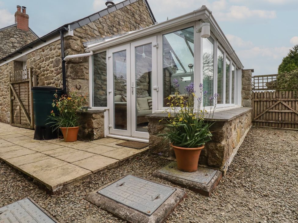 A conservatory with potted plants at The Smithy in Blisland
