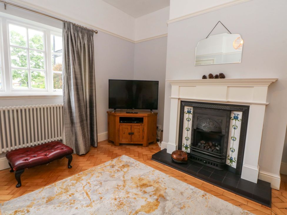 A living room with a television cabinet and fireplace at Sunlight Soap Cottage Port Sunlight