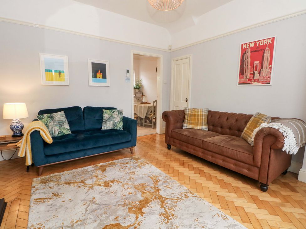 A living room with two sofas and a rug at Sunlight Soap Cottage in Port Sunlight