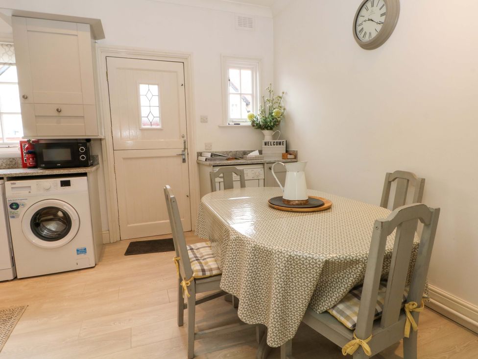 A kitchen with a table and chairs at Sunlight Soap Cottage in Port Sunlight