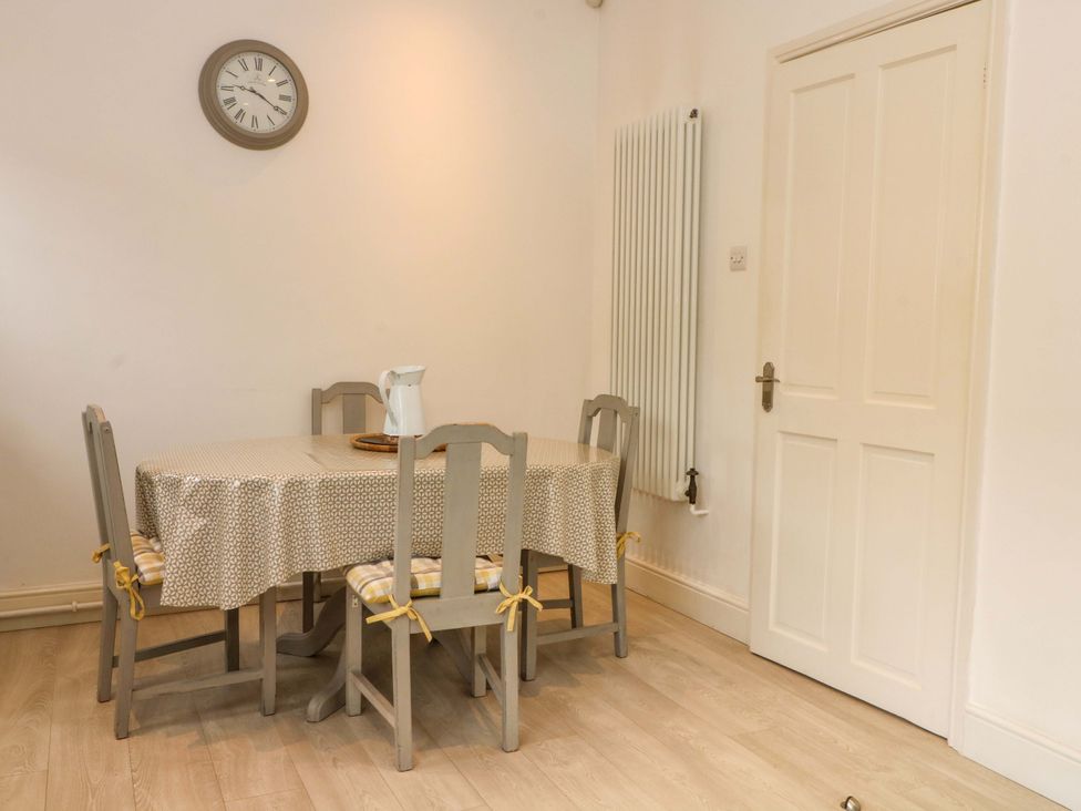 A dining room with a table and chairs at Sunlight Soap Cottage in Port Sunlight