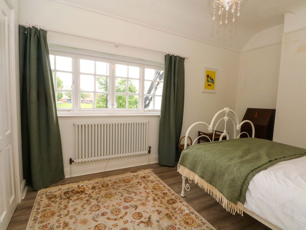A bedroom with a bed and window at Sunlight Soap Cottage Port Sunlight