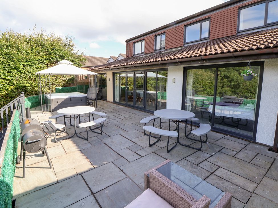 An outdoor patio with seating and a hot tub at Talgais in Llangollen