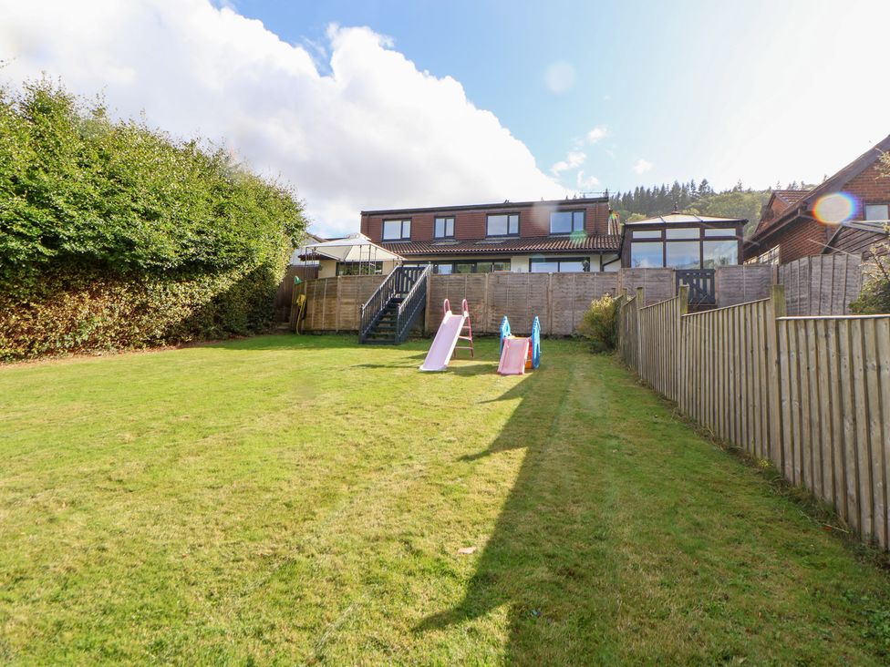 A garden with slides and grass at Talgais in Llangollen