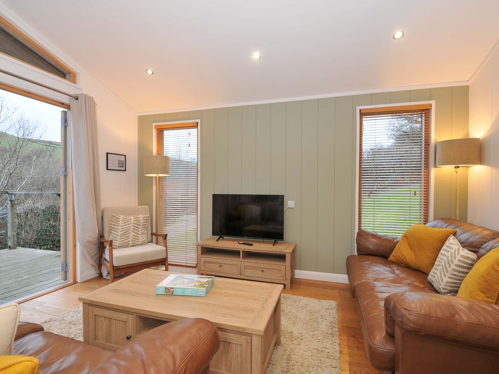 A living room with a sofa and television at 6 Hedgerows in Lanreath