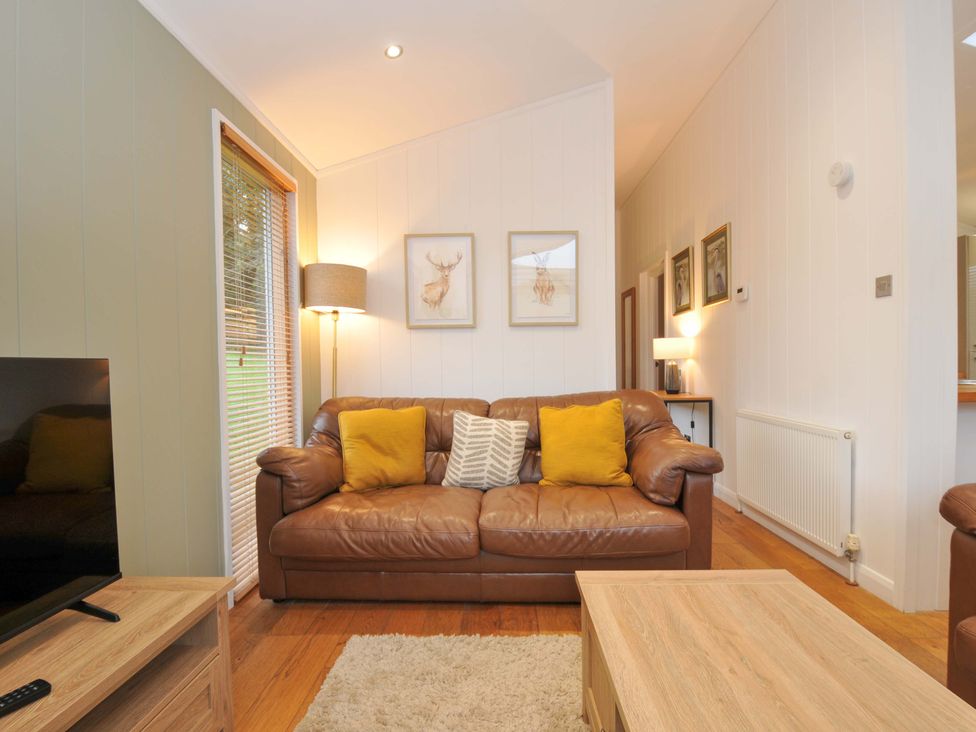 A living room with a sofa and television at 6 Hedgerows in Lanreath