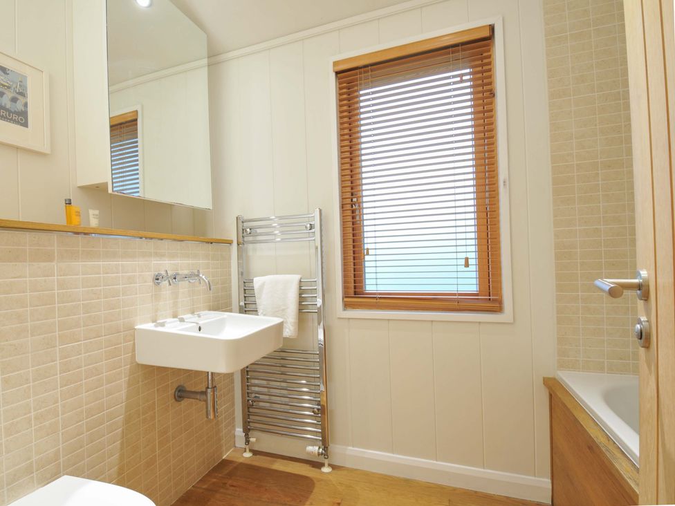 A bathroom with a sink and towel rack at 6 Hedgerows in Lanreath