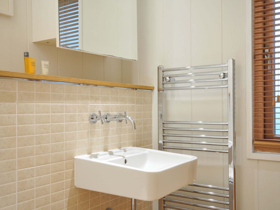 A bathroom with a sink and towel rail at 6 Hedgerows in Lanreath
