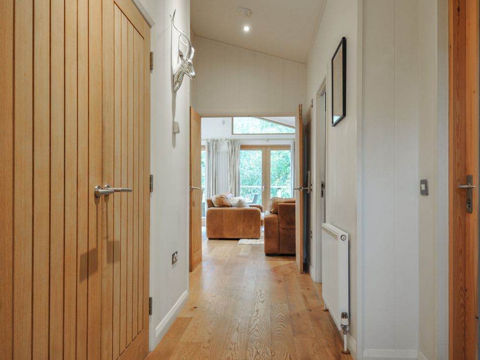 A hallway leading to a living room with a sofa at 2 Streamside in Looe