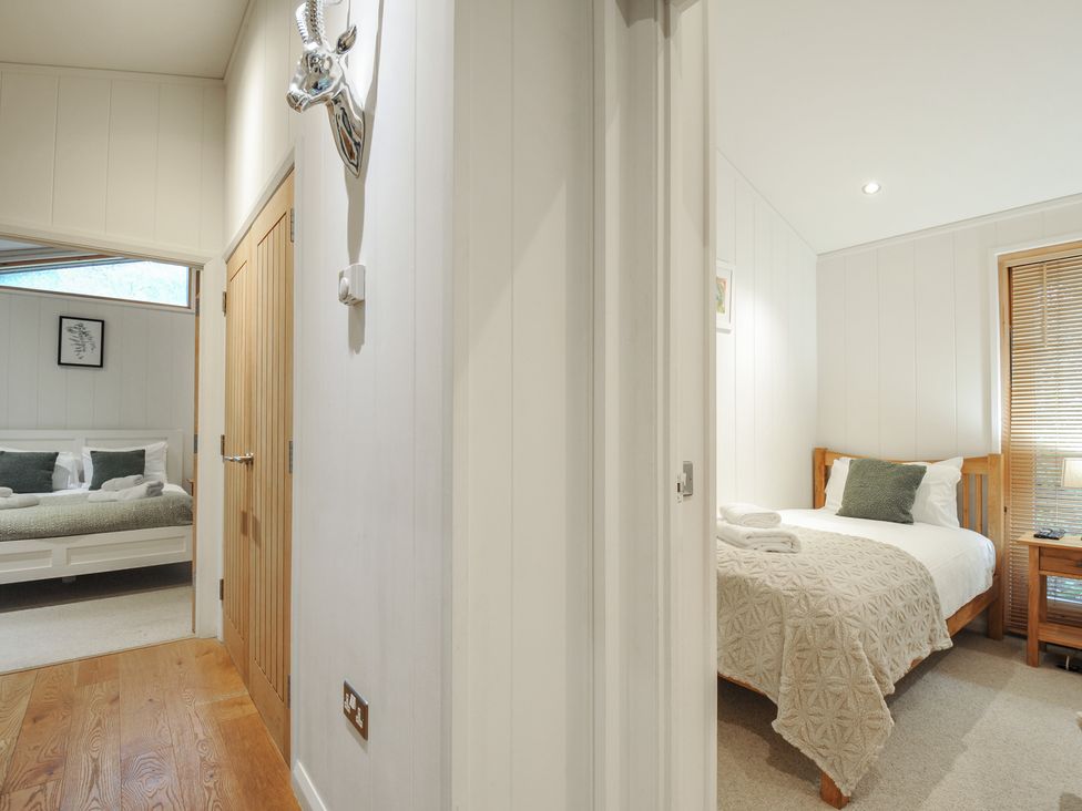 A hallway with a view into a bedroom at 2 Streamside Looe
