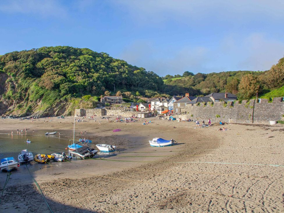 A beach with boats and houses at 7 Streamside in Lanreath