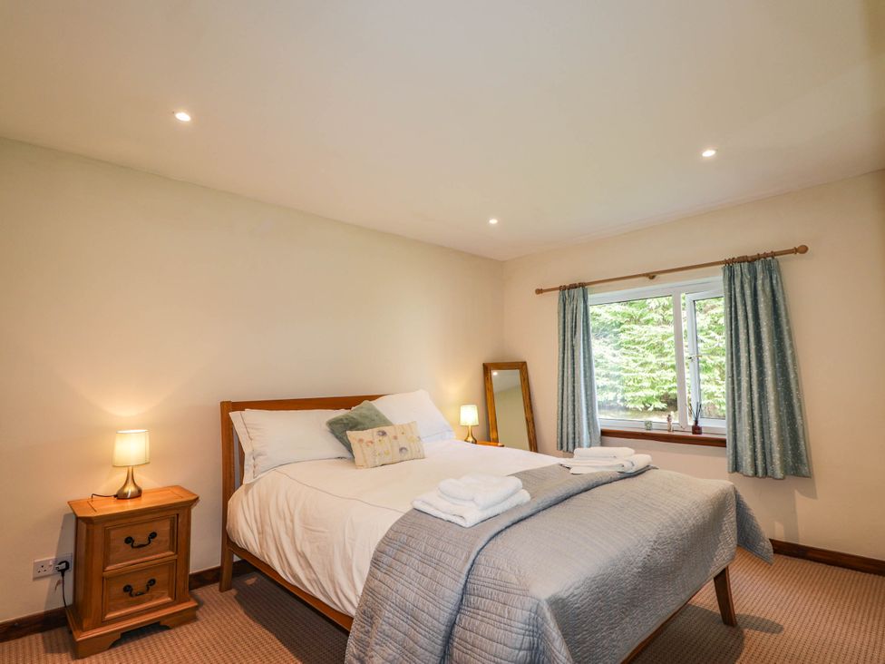 A bedroom with a bed and window at St. Aethans in Bonar Bridge