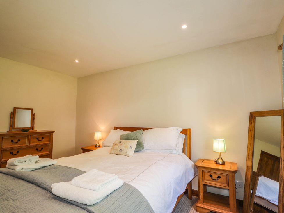 A bedroom with a bed and bedside table at St. Aethans in Bonar Bridge