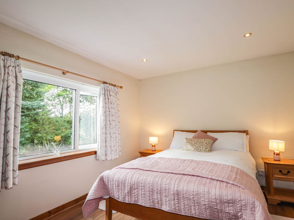 A bedroom with a bed and nightstands at St. Aethans in Bonar Bridge