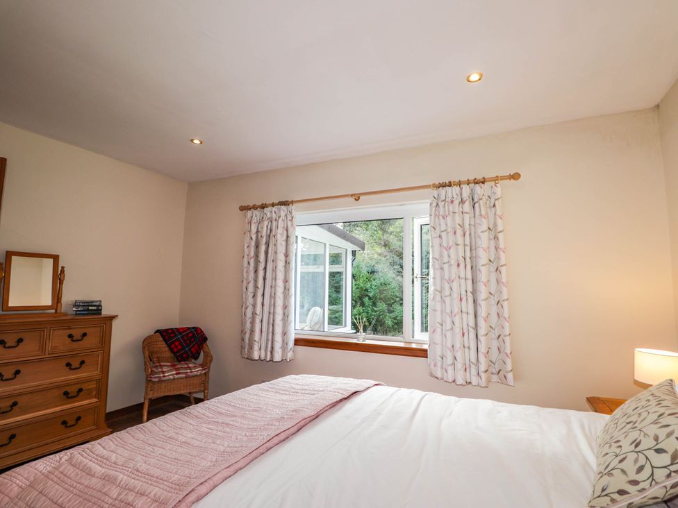 A bedroom with a bed and dresser at St. Aethans in Bonar Bridge