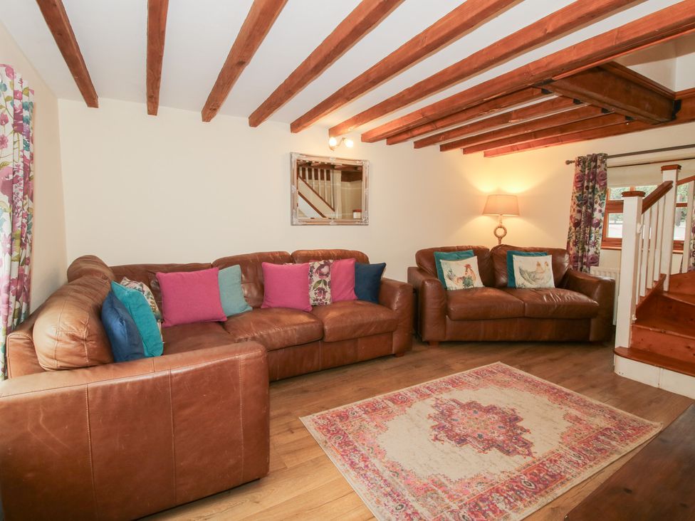 A living room with a sofa and rug at Old Hall Barn 4, Church Stretton