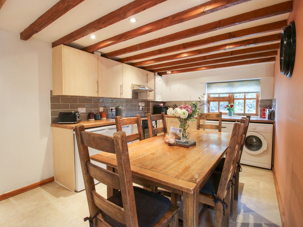 A kitchen with a dining table and chairs at Old Hall Barn 4 Church Stretton