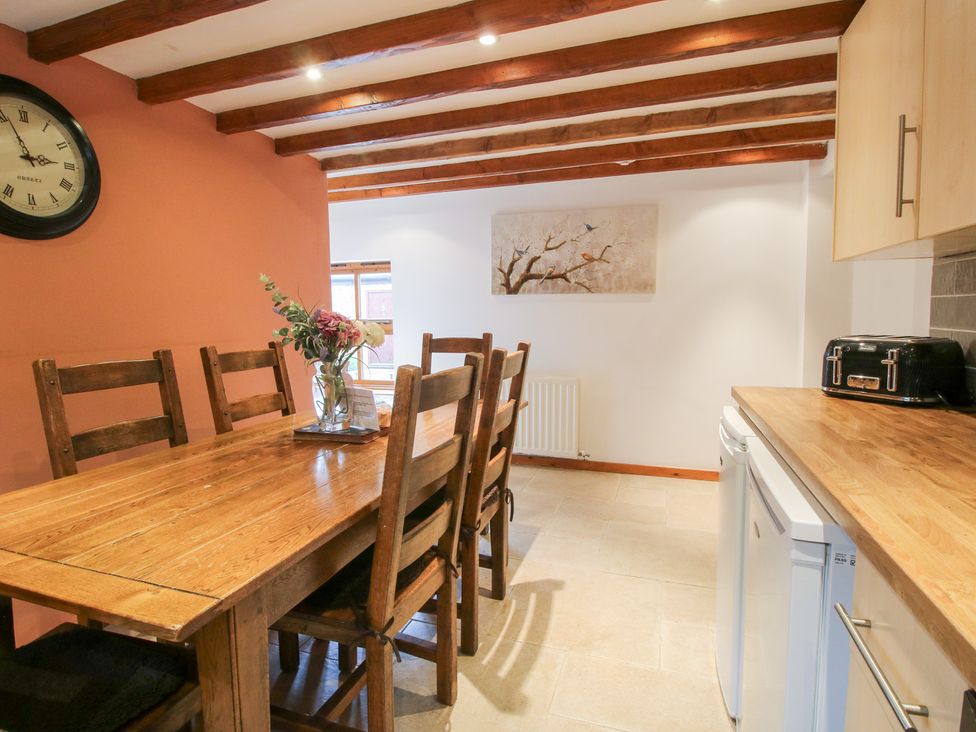 A kitchen with a dining table and chairs at Old Hall Barn 4 Church Stretton