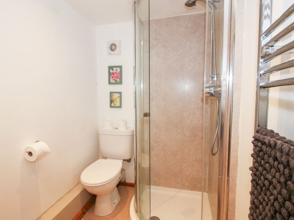 A bathroom featuring a shower and toilet at Old Hall Barn 4, Church Stretton