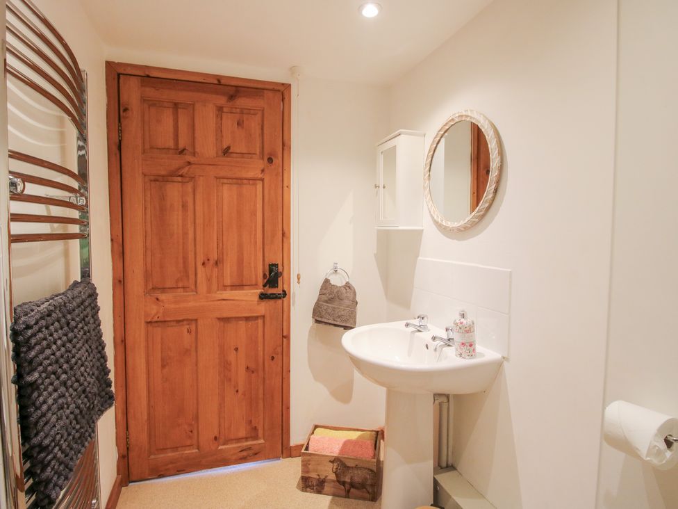 A bathroom with a sink and mirror at Old Hall Barn 4, Church Stretton