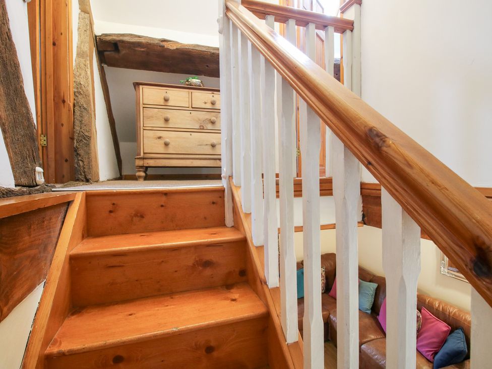 A staircase leading to an upper level with a dresser at Old Hall Barn 4, Church Stretton
