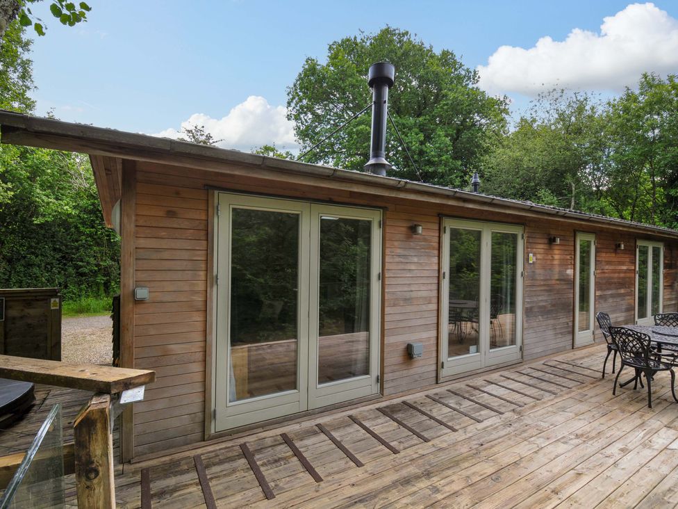 A wooden cabin with a deck and outdoor seating at 14 Stonerush Valley, Lanreath
