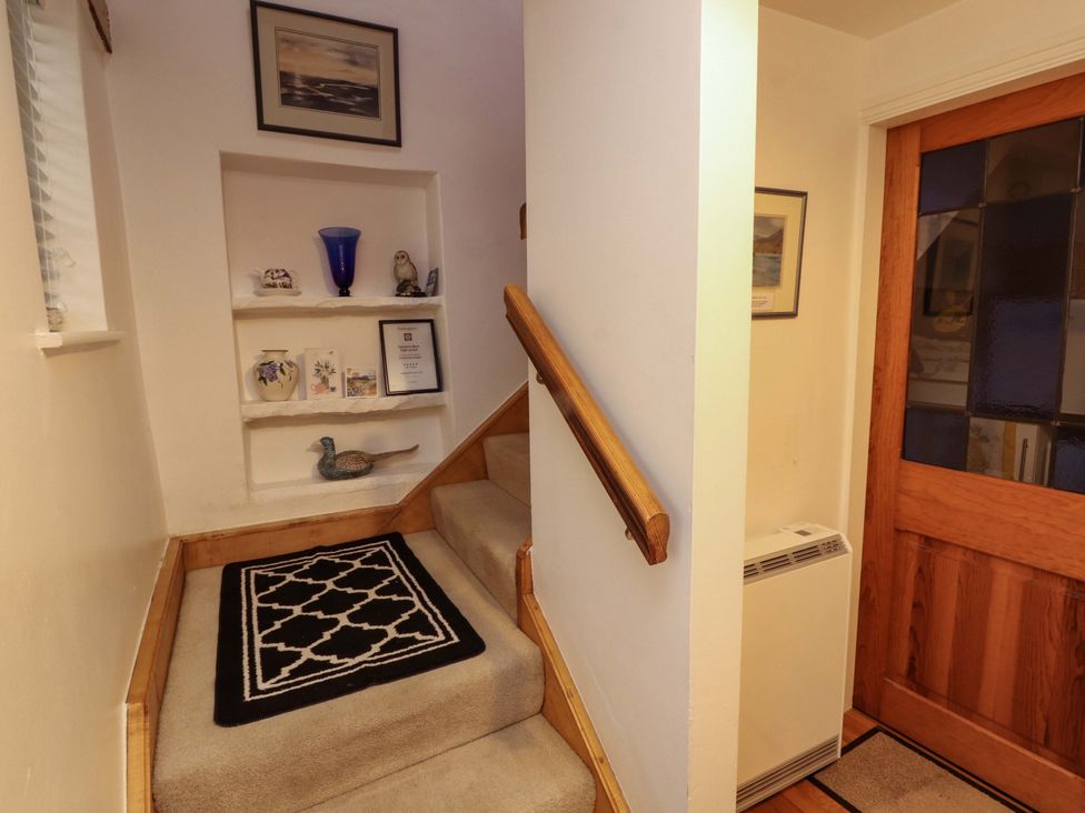 A staircase with a handrail in a hallway at Holemire Barn in Lorton