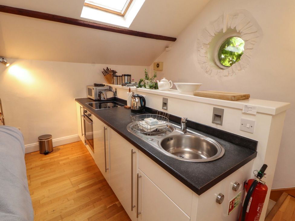 A kitchen with appliances and a sink at Holemire Barn in Lorton