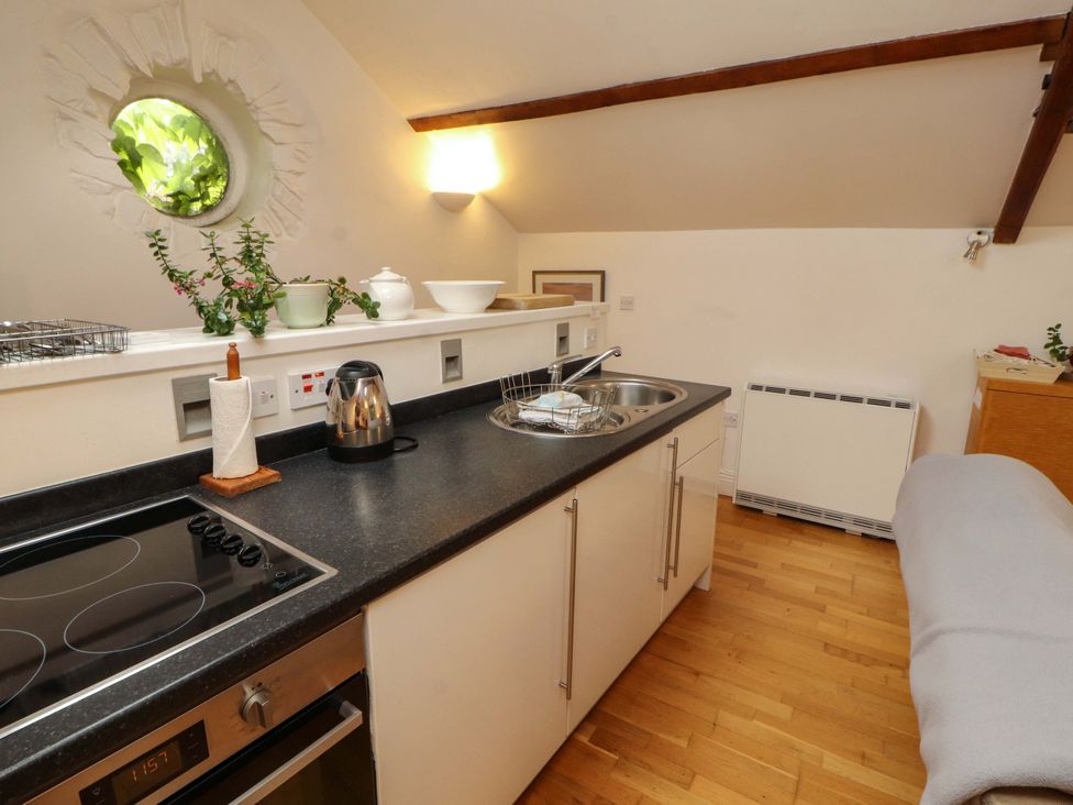 A kitchen with a stove and sink at Holemire Barn in Lorton