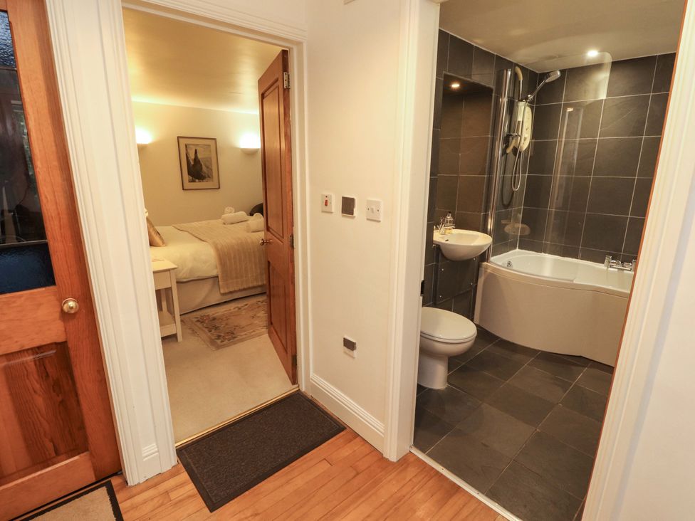 A bathroom with a bath tub and shower at Holemire Barn in Lorton