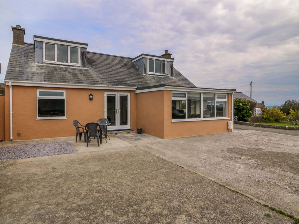 An outdoor view of a house with seating at Dalar Deg in Aberdaron